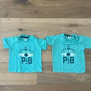 Two t shirts. Green. 2T. Label says 3y but measures small